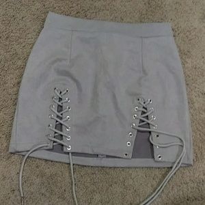 To never worn faux suede lace-up mini skirts
